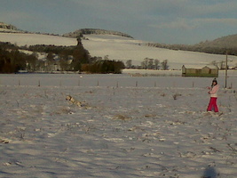Erynn &amp; Max making footprints in field of snow